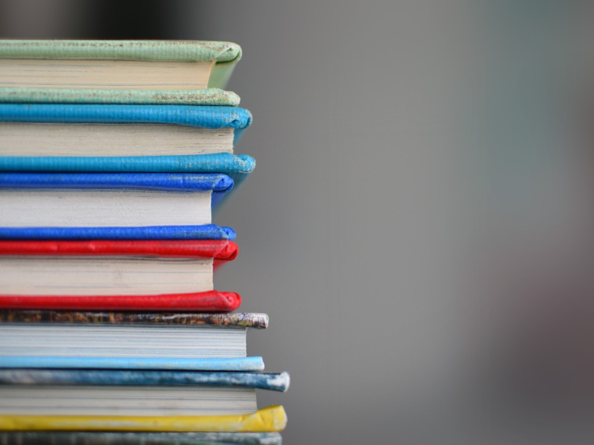 Warm educational scene with stacked books, colored pencils, and learning materials